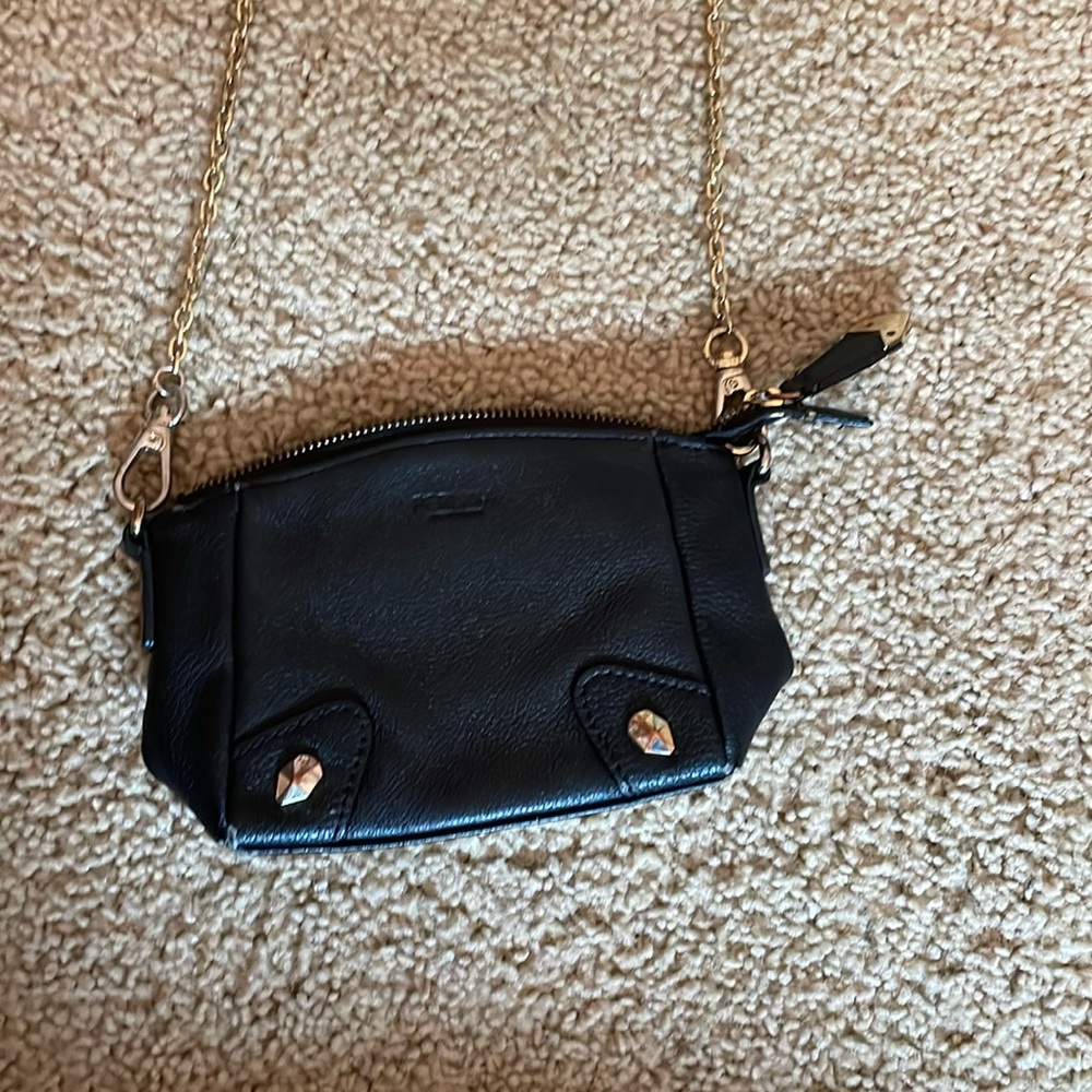 Perlina New York black purse with gold chain strap.